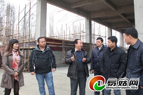 德江县高山天麻示范场总经理曾宪强（左三）为考察人员介绍正在建设中的天麻加工车间